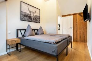 a bedroom with a bed with a picture of a deer on the wall at Pendler- und Ferienwohnung Bröke in Ahaus