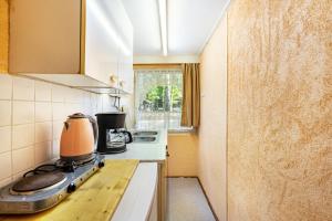 a small kitchen with an orange appliance on a counter at Bungalow 6 - Finnhütte in Niesky