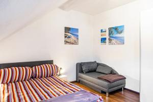 a living room with a couch and a chair at Ferienwohnung Thüringer Wald in Ilmenau