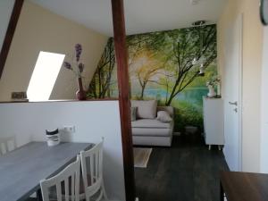 a dining room with a painting on the wall at Am Froschteich in Dolgen +20 photos