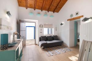 a living room with a couch and a table at Quinta do Mestre - Casa Do Mar in Tavira