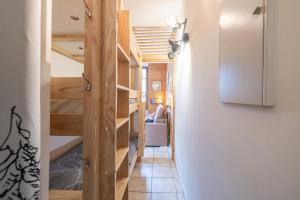 a hallway leading to a room with bunk beds at Les Narcisses in Morillon