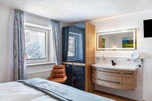 a bathroom with a sink and a mirror at Apart Elena in See