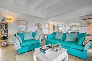 a living room with blue couches and a coffee table at Ayora in Jávea