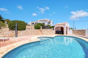 a swimming pool in a yard with a house at Ayora in Jávea