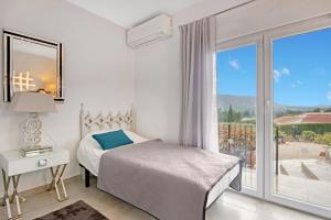 a bedroom with a bed and a large window at Ayora in Jávea +28 photos