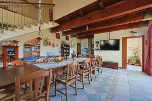 a large dining room with a long table and chairs at Bed And Breakfast Sciarammola in Patti