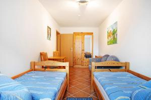 a room with two beds and a table and chairs at Haus Seeadler Wohnung 10 in Koserow