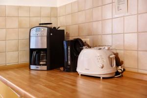 a kitchen counter with a toaster and a coffee maker at Haus Seeadler Wohnung 10 in Koserow