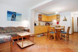 a living room with a couch and a table and a kitchen at Haus Seeadler Wohnung 10 in Koserow