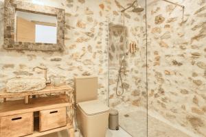 a bathroom with a shower with a toilet and a sink at Casa Stone in Benissa +20 photos