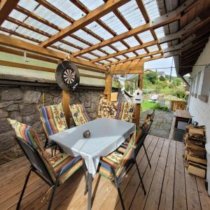 a patio with a table and chairs on a deck at Ferienwohnung Härtel in Schramberg