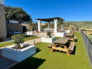 a park with picnic tables and a gazebo at Avalon in Setenil in Setenil