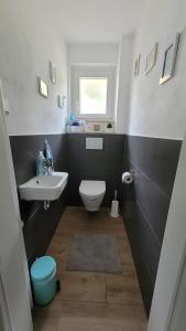 a bathroom with a white sink and a toilet at Ferienwohnung Härtel in Schramberg +15 photos