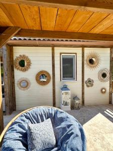 a porch with a bed and a wooden ceiling at Campo Vecchio Mare et Piscine in Ghisonaccia