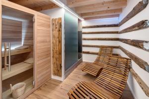 a room with two chairs and a sauna at Thari House Dolomiti in Piaia +24 photos