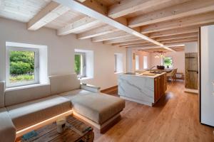 a living room with a couch and a table at Thari House Dolomiti in Piaia