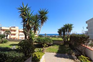 a view of the beach from a building with palm trees at Casa Kefera a Otranto in Otranto