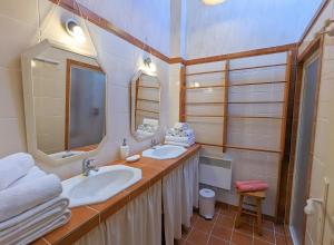 a bathroom with two sinks and a mirror at Le Clos Pierreslogis in Theil-Rabier +12 photos