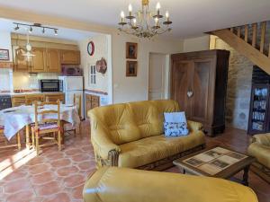 a living room with a couch and a table at Le Clos Pierreslogis in Theil-Rabier