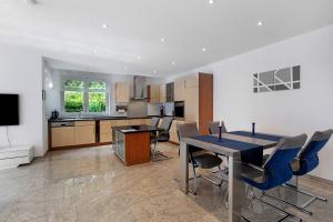 a kitchen and dining room with a table and chairs at Ferienwohnung Milita in Lörrach