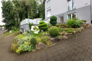 a garden with flowers and plants in front of a house at Ferienwohnung Milita in Lörrach