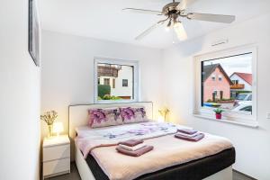 a bedroom with a bed with towels on it at Ferien Marx in Oberbrechen +36 photos