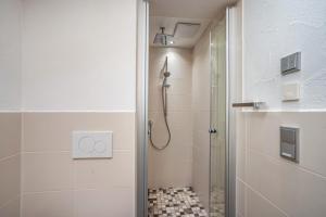 a bathroom with a shower and a glass door at Appartement Braun 1 in Bolsterlang +17 photos