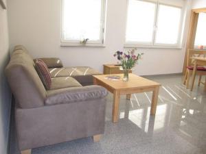 a living room with a couch and a coffee table at Apfelhof - Ferienwohnung Wielath in Salem