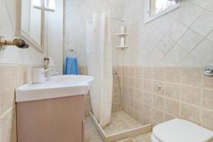 a bathroom with a toilet and a sink and a shower at The Sea Martin in Nydri +23 photos