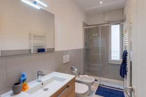 a bathroom with a sink and a toilet and a shower at Casa Daniele Vista Mare - Sanremo in Sanremo +19 photos
