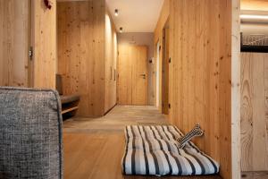 a room with wood paneling and a bed on the floor at Apartment Silvy am Schlern in Völs am Schlern