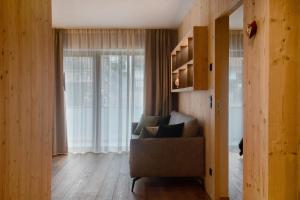 a living room with a couch and a window at Apartment Silvy am Schlern in Völs am Schlern