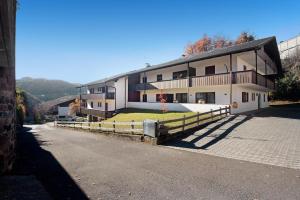 a large building with a fence in front of it at Apartment Silvy am Schlern in Völs am Schlern