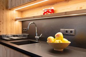 a kitchen with a sink and a bowl of fruit at Apartment Silvy am Schlern in Völs am Schlern