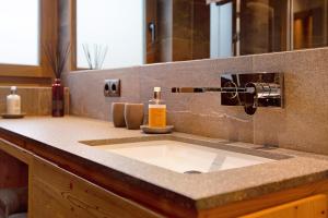 a bathroom counter with a sink and a mirror at Apartment Silvy am Schlern in Völs am Schlern +19 photos