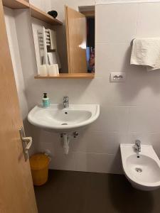 a bathroom with a sink and a toilet at App Sonne Nr 15 in Lutago