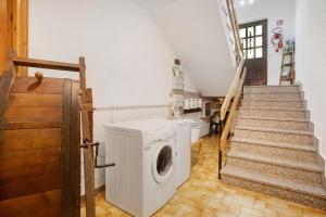 a washer and dryer in a room with stairs at Maison Le Cré Appartamento 2 in Introd