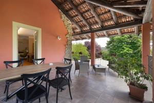 a dining room with a wooden table and chairs at Cascina Manzo in Dogliani