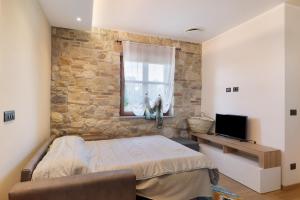 a bedroom with a bed and a window at Cascina Manzo in Dogliani