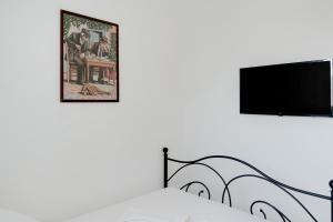 a bedroom with a bed and a flat screen tv at Politimis Studio N4 in Amorgos +21 photos
