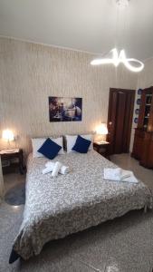 a bedroom with a large bed with towels on it at La Casa di Giosy in Cairo Montenotte