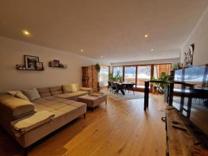 a living room with a couch and a table at Exclusive 120 qm Wohnung am Wössner in Unterwössen
