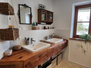 a bathroom with two sinks on a wooden counter at Exclusive 120 qm Wohnung am Wössner in Unterwössen +30 photos