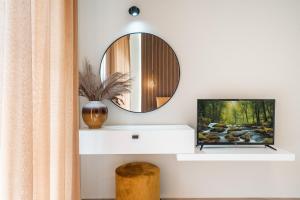 a living room with a tv and a mirror at Eldorado Luxury Villa in Afantou
