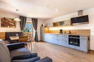 a kitchen and living room with a couch and a table at Lechnerhof Wilde Kreuzspitze in Valles