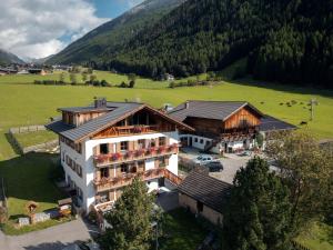 an aerial view of a building in a field at Lechnerhof Wilde Kreuzspitze in Valles