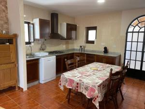 a kitchen with a table with a table cloth on it at Casa de Antonio con piscina privada in Moratalla +23 photos