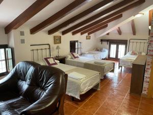 a living room with two beds and a couch at Casa de Antonio con piscina privada in Moratalla