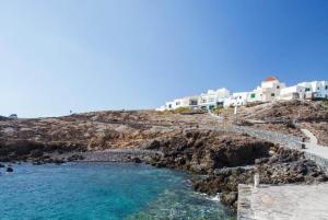 a group of white houses on a rocky hill with the ocean at Beach House el Poris 2 in Poris de Abona